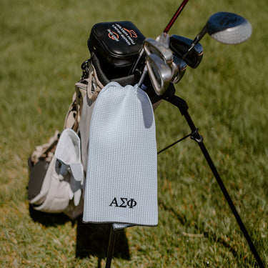 A-Sig Greek letters embroidered on a white golf towel.