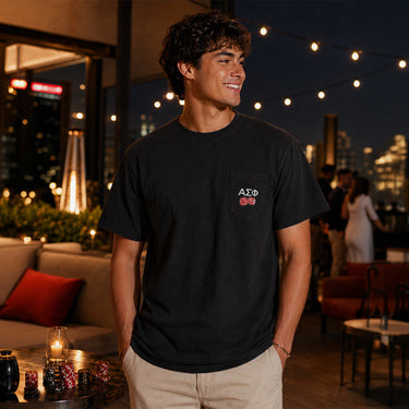 Model wearing the High Roller Tee from the front, featuring a chest pocket dice graphic on a black Comfort Colors tee.