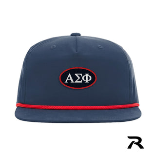 A navy blue performance snapback hat featuring a red rope detail and a central navy oval patch with a red embroidered border.