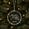 Limited Edition glass Christmas ornament with engraved design hanging on a decorated holiday tree